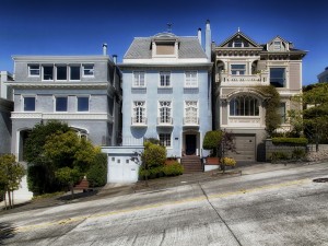 3 homes on a slanted hill.